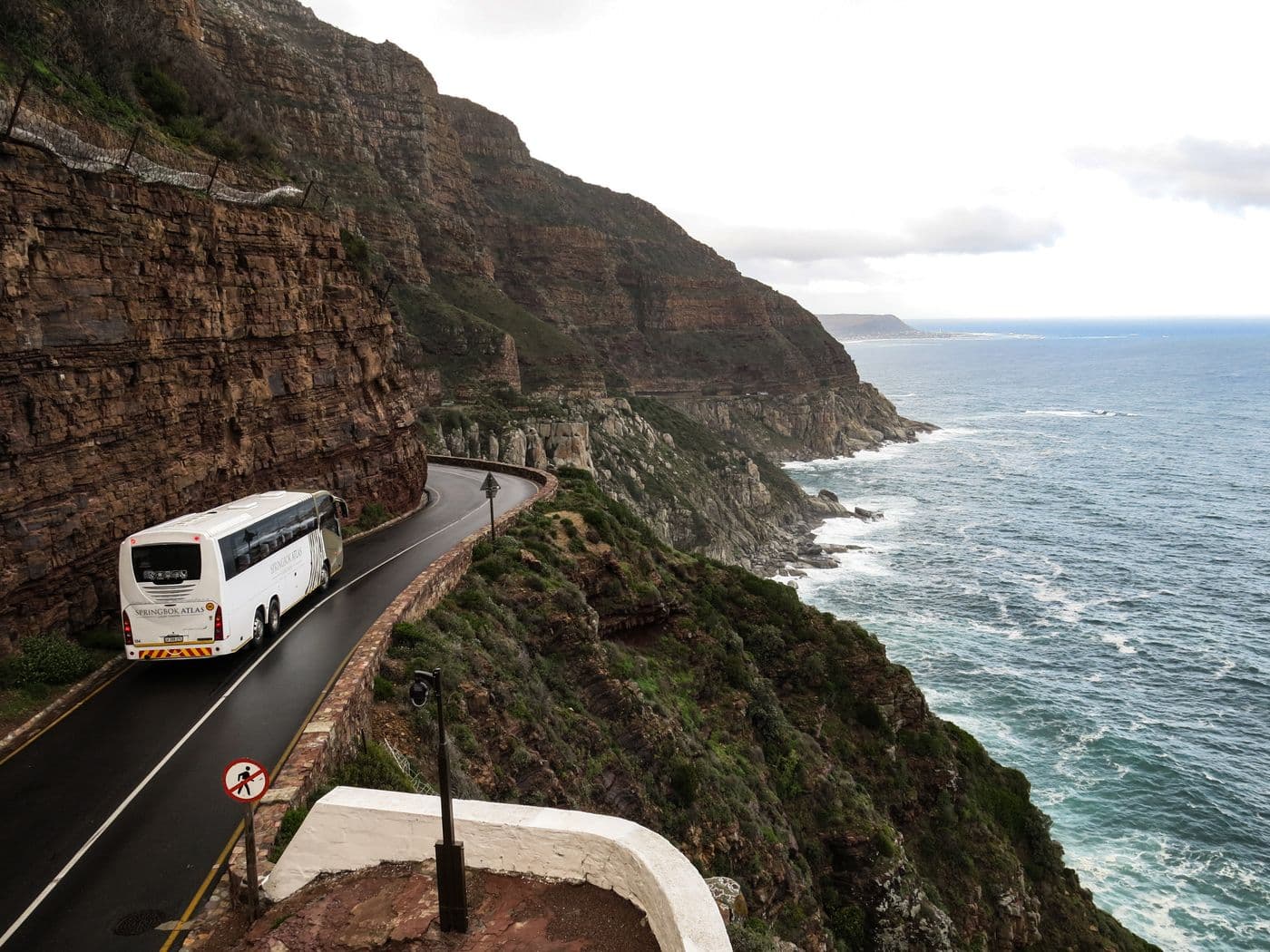 Tour coach on a coastal cliff road for group and minibus hire